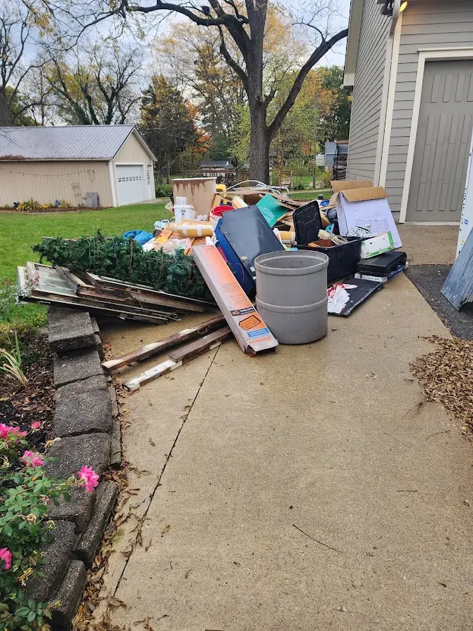 Dumpster being loaded with debris for Estate Cleanout Dumpster Rental in Auburn